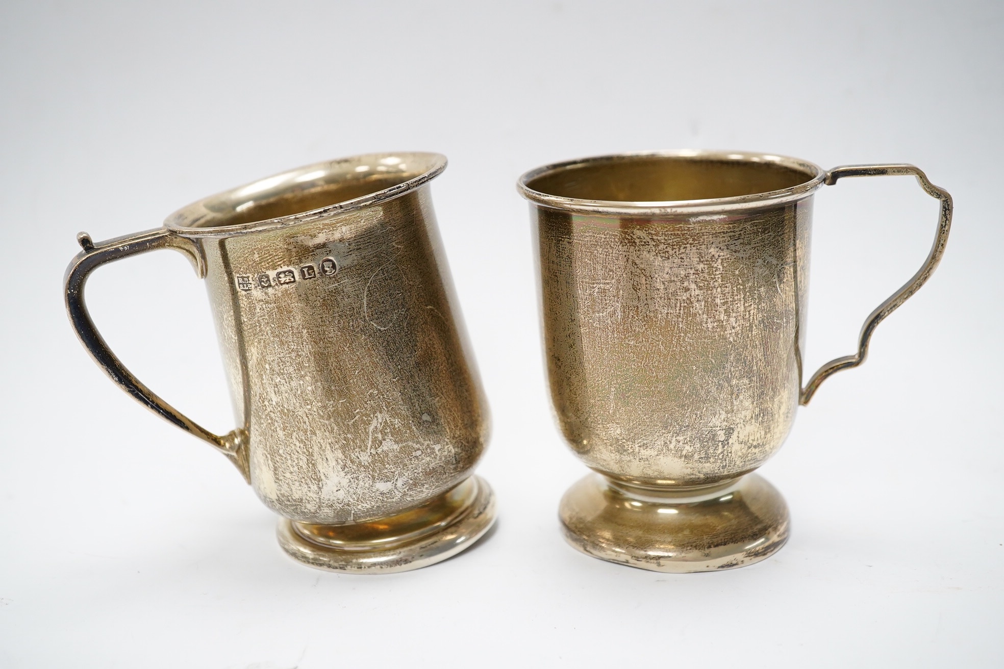 Six items of small silver:- two christening mugs, a cream jug, a salt, an egg cup and a box lid. Condition - poor to fair